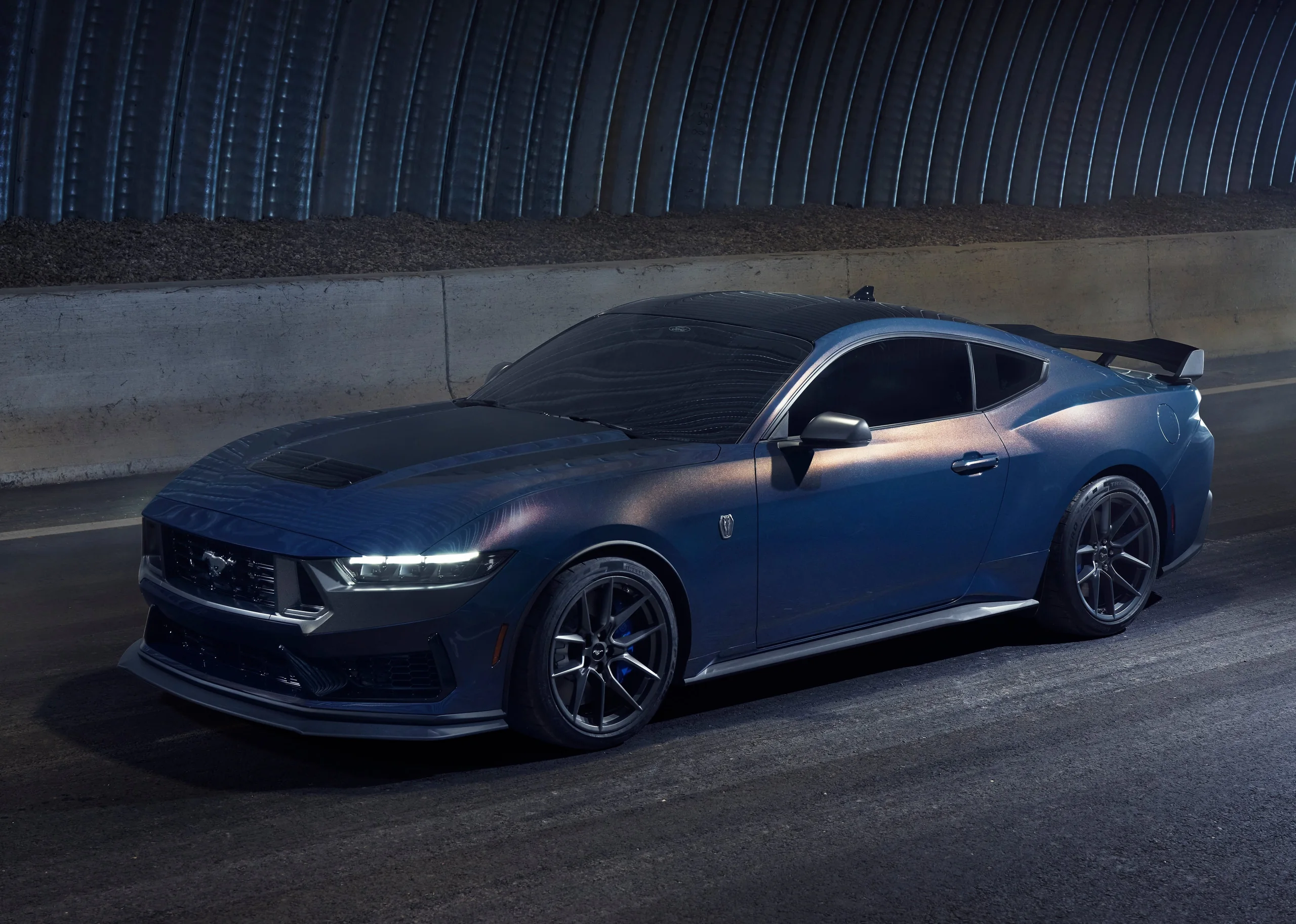 Blue performance vehicle in a dark tunnel representing real-world vehicle systems